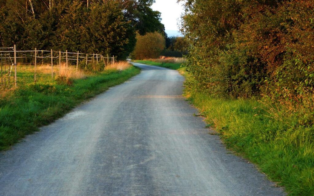 a curving road in a rural countryside.