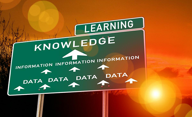 a sign with the words learning, knowledge, information, data illlustrating the certainty trap.
