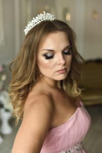 a young woman wearing a tiara to illustrate the princess syndrome.