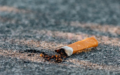 close up of cigarette butt on road, image by Storme Kovacs from Pixabay.