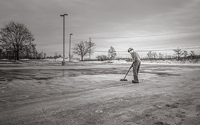 Person sweeping parking lot image by Ryan McGuire from Pixabay.