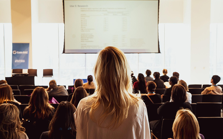 people listening to speaker at seminar.